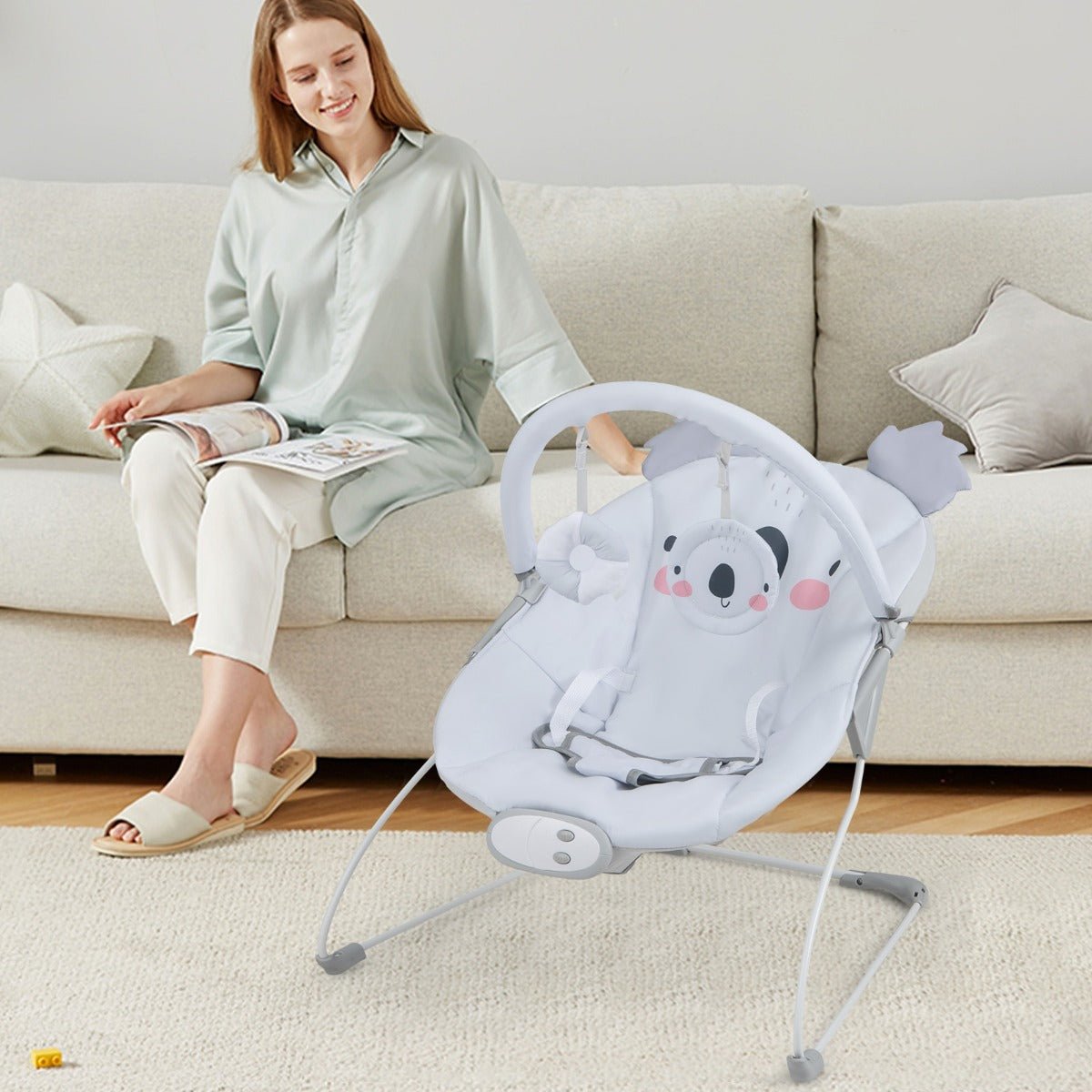 Baby rocker seat with music and toys for soothing infant bouncer at home.