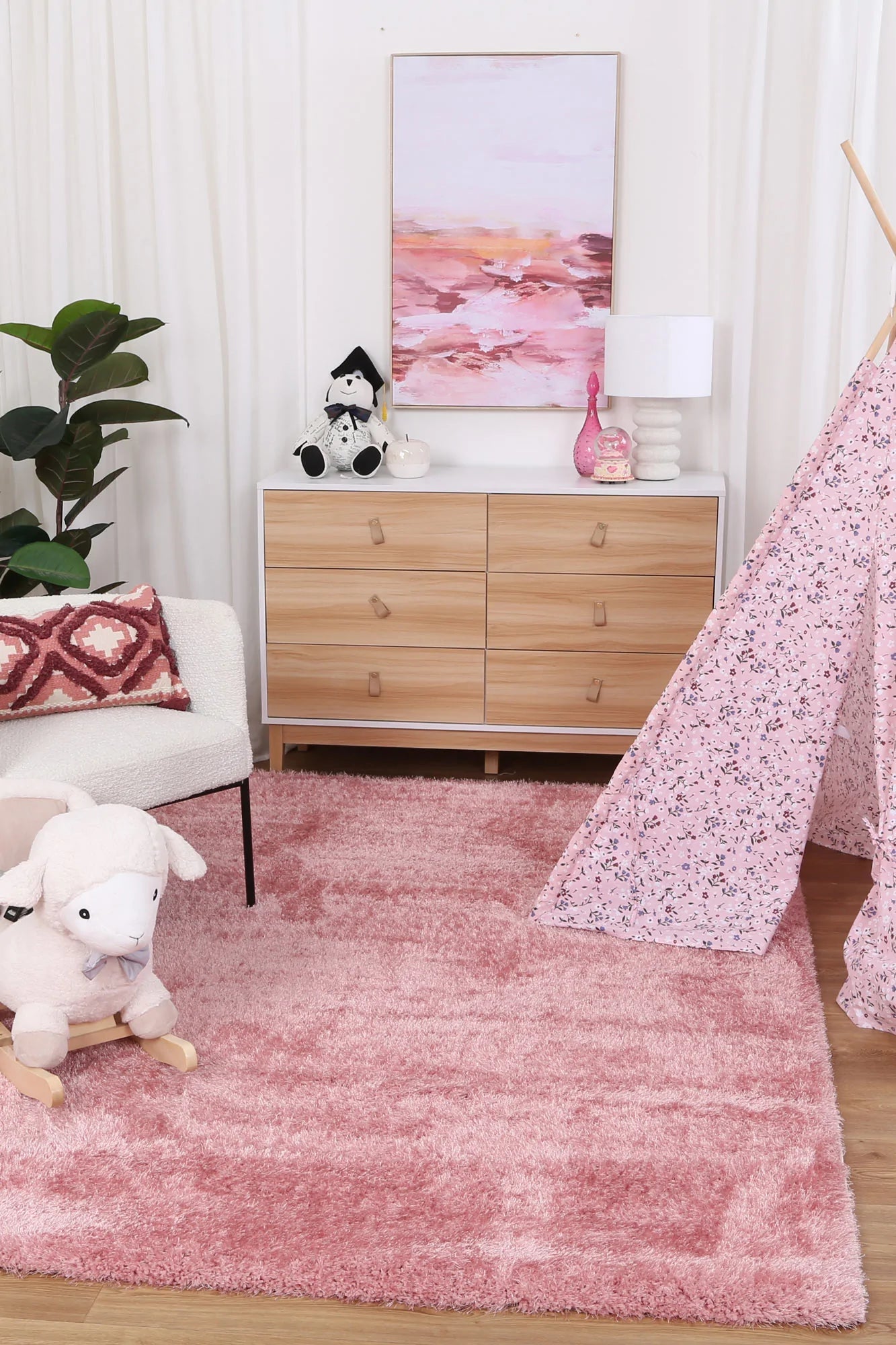 Soft and playful pink shag rug perfect for kids rooms, adding cozy charm.