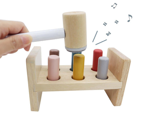 Childrens hammer bench toy with squeaky sound for interactive play and developmental activity.