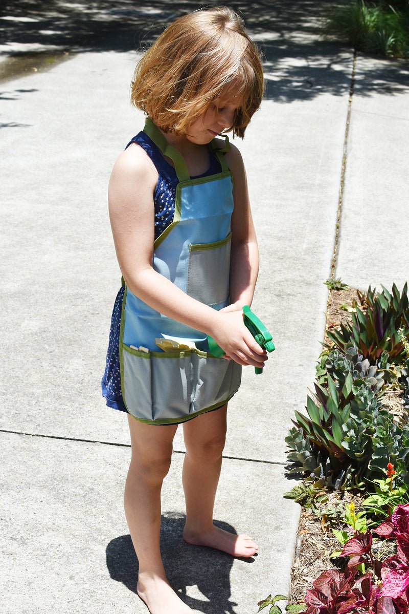 Kids garden tool apron in calming design for young gardeners, promoting organization and fun.