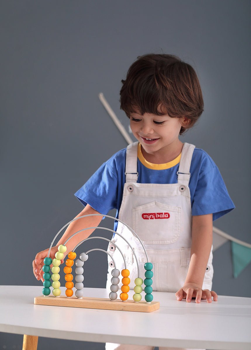 Colorful abacus toy with rainbow beads for educational play at home for children.