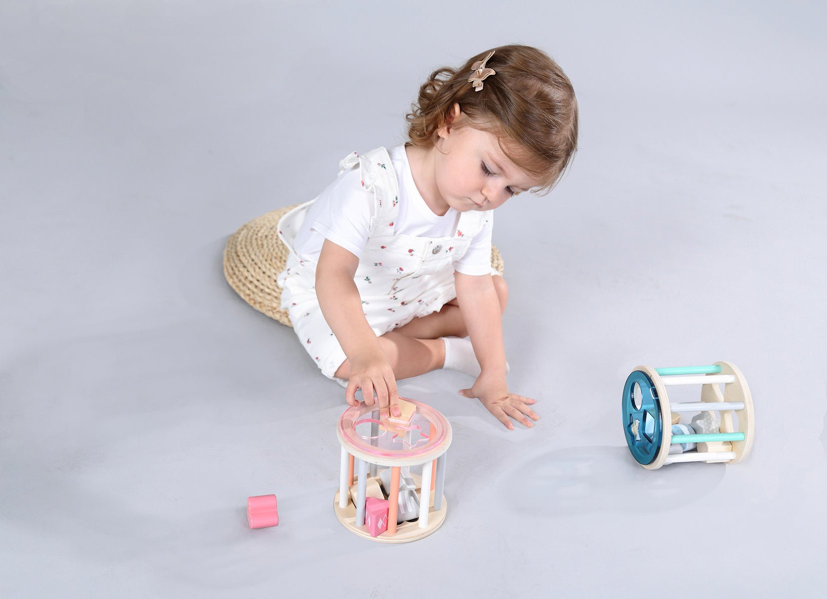 Blue rolling shape sorter toy for fun sorting and motor skill development in children.