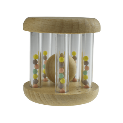 Wooden baby rattle with colorful rainbow bead for soothing playtime at home.