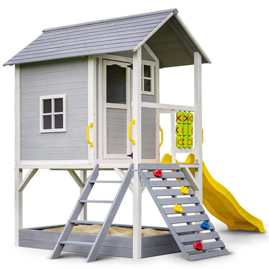 Grey cubby house featuring slide, rock wall, and noughts and crosses, ideal for kids play.