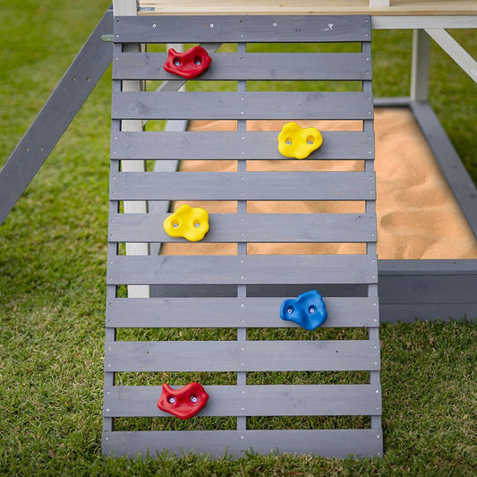 Grey cubby house with slide, rock wall, and noughts and crosses game - perfect for kids backyard fun.