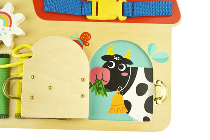 Farm-themed busy board toy for kids, complete with interactive barn, ideal for imaginative play.