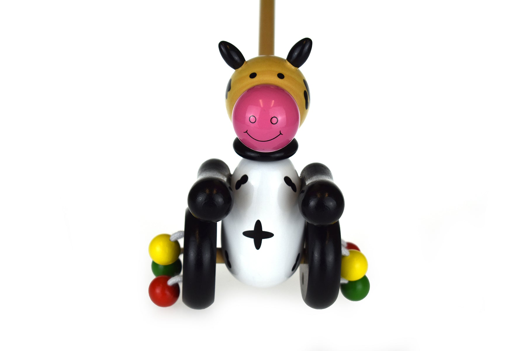 Wooden push along cow toy perfect for toddlers, encourages fine motor skills and imaginative play.