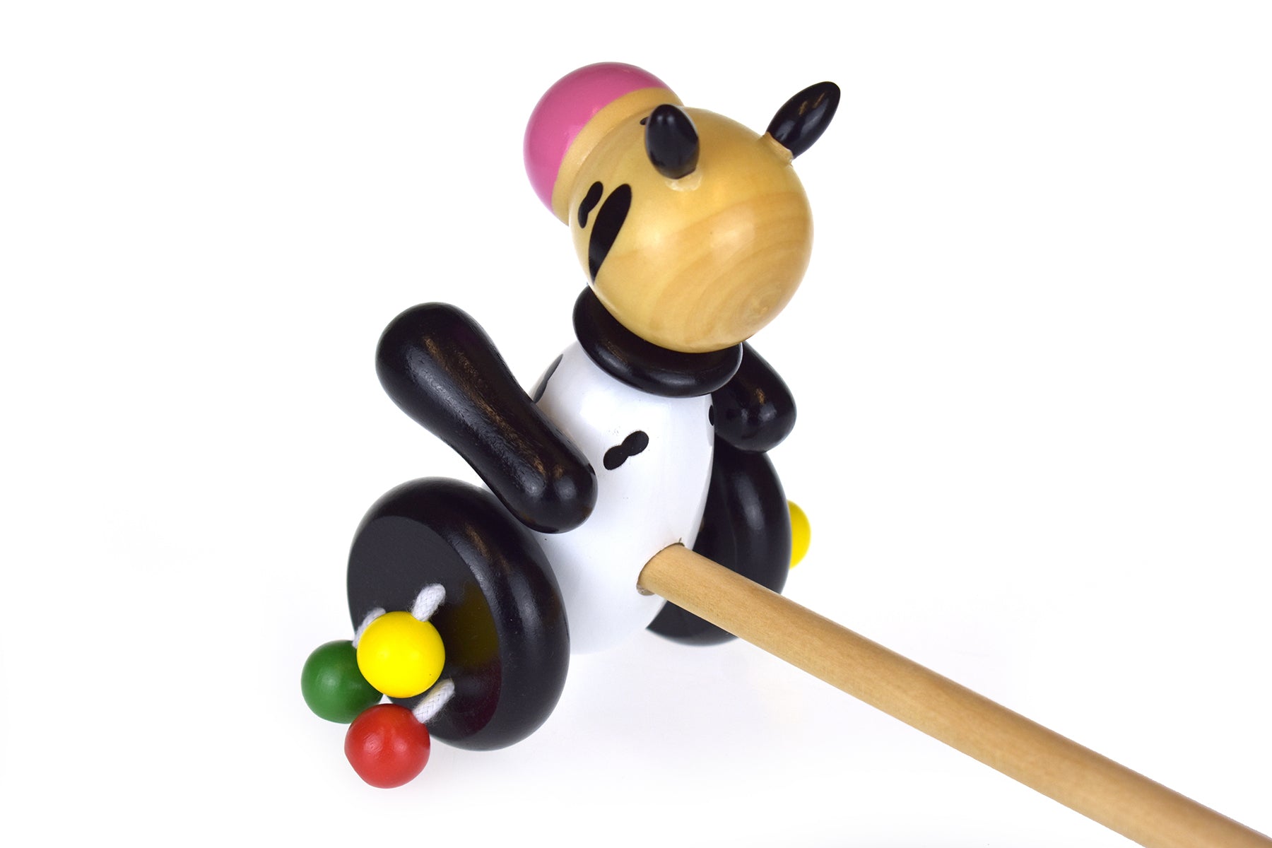 Wooden push along cow toy for interactive play, ideal for stimulating childrens imagination at home.