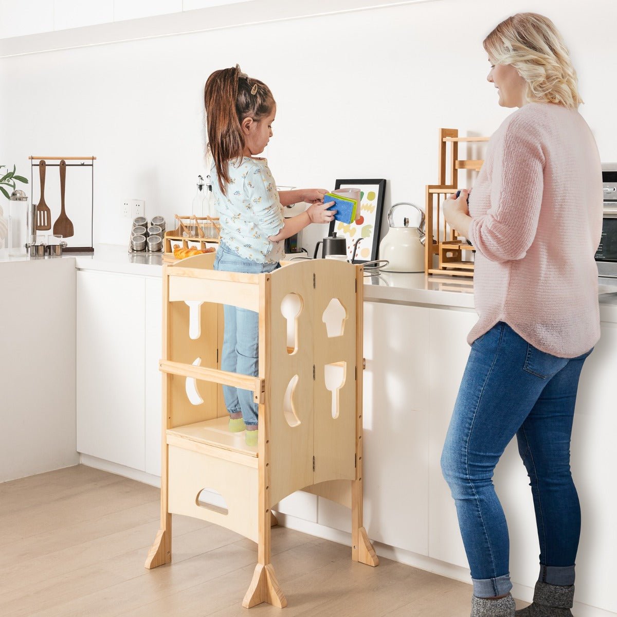 Kid-friendly wooden step stool with adjustable height for kitchen activities and independence.