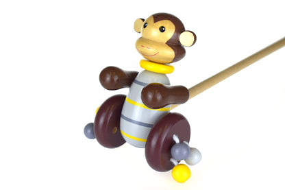 Colorful wooden push along monkey toy, ideal for active play in kids rooms.