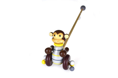 Colorful wooden push along monkey toy for interactive play and motor skills development.