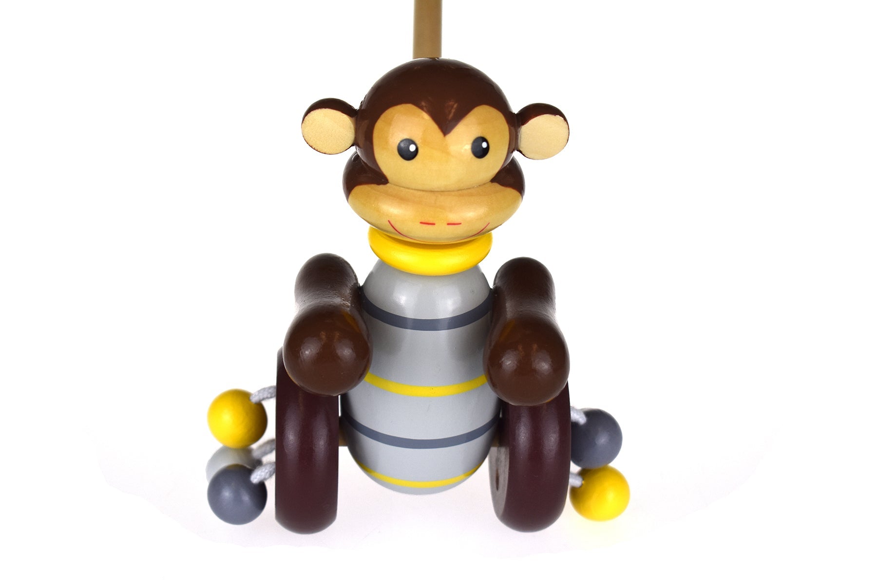 Colorful wooden push along monkey toy for interactive playtime in a jungle-themed setting.