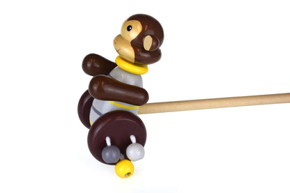 Colorful wooden push along monkey toy for kids, stimulating imaginative play at home.