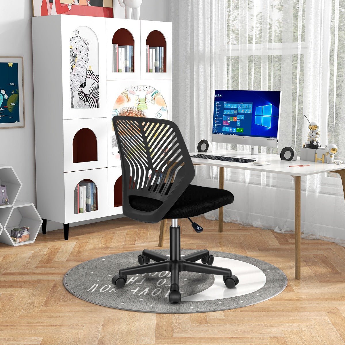 Black kids mesh office chair with adjustable height and wheels for comfortable home studying.