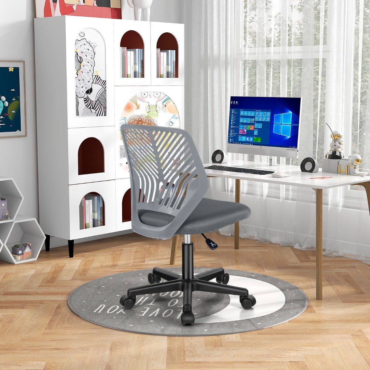 Kids grey mesh office chair with adjustable height and wheels for ergonomic home study.