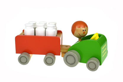 Colorful toy tractor with milk bottle pins for fun and interactive indoor bowling game.