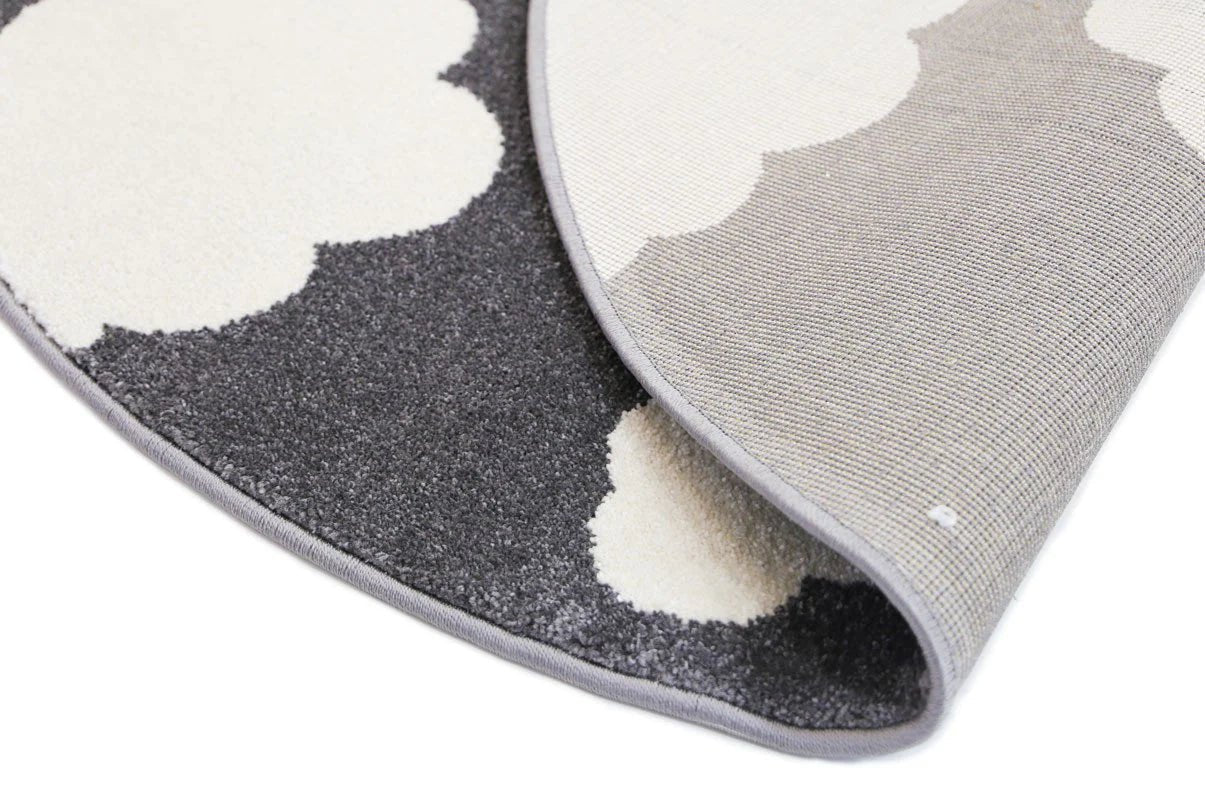 Dark grey and white kid rug with whimsical clouds design, ideal for childrens bedroom decor.