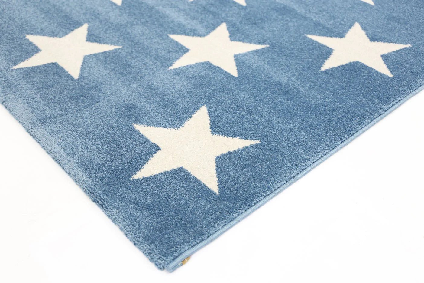 Petit Stars blue and white kids rug, perfect for enhancing playrooms and bedrooms.