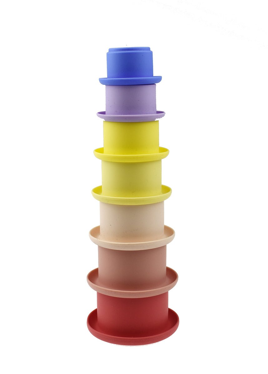 7-piece pink stacking cups set made of silicone for kids educational playtime at home.