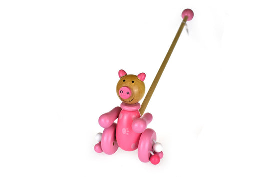 Wooden push along pig toy with playful trotter design for interactive fun at home.