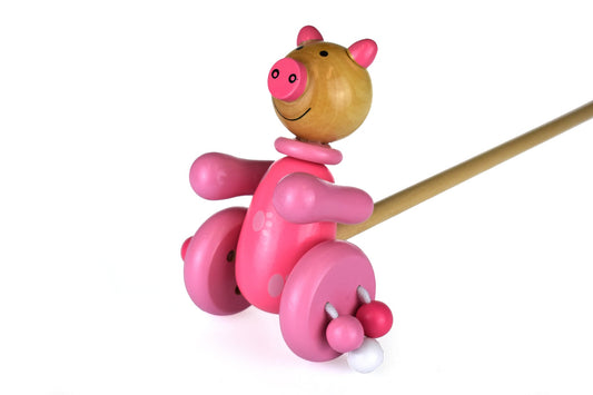 Wooden push along pig toy for toddlers, encourages active play and imaginative fun at home.