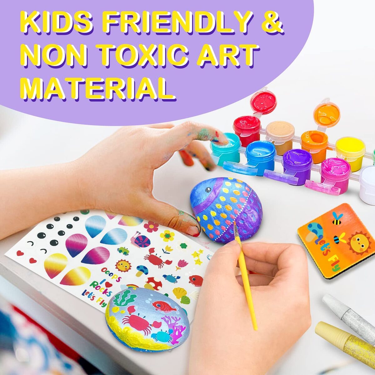 Colorful rock painting kit with metallic paints and glitter glue for creative kids at home.