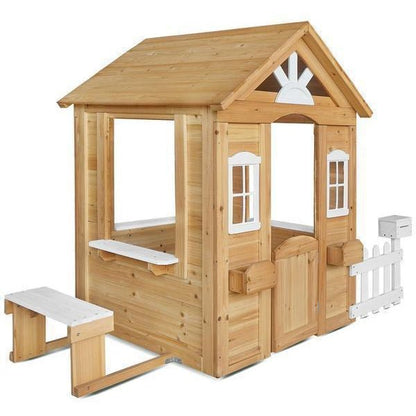 Kids outdoor playhouse with charming picket fence, perfect for imaginative play in natural setting.