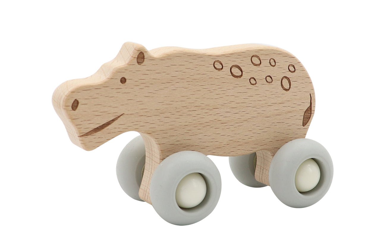 Wooden hippopotamus toy with durable silicone wheels for engaging playtime at home.