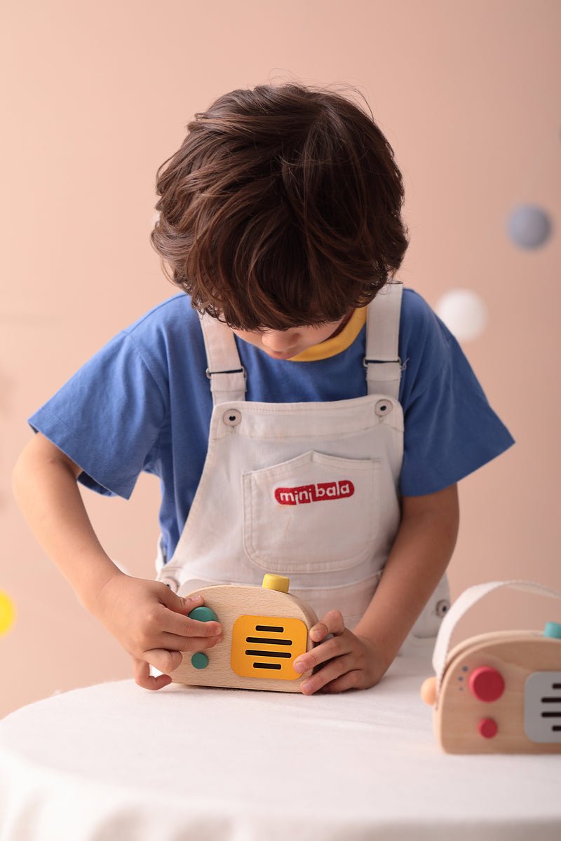 Kid-friendly wooden toy radio music box in vintage green transistor design for imaginative play.