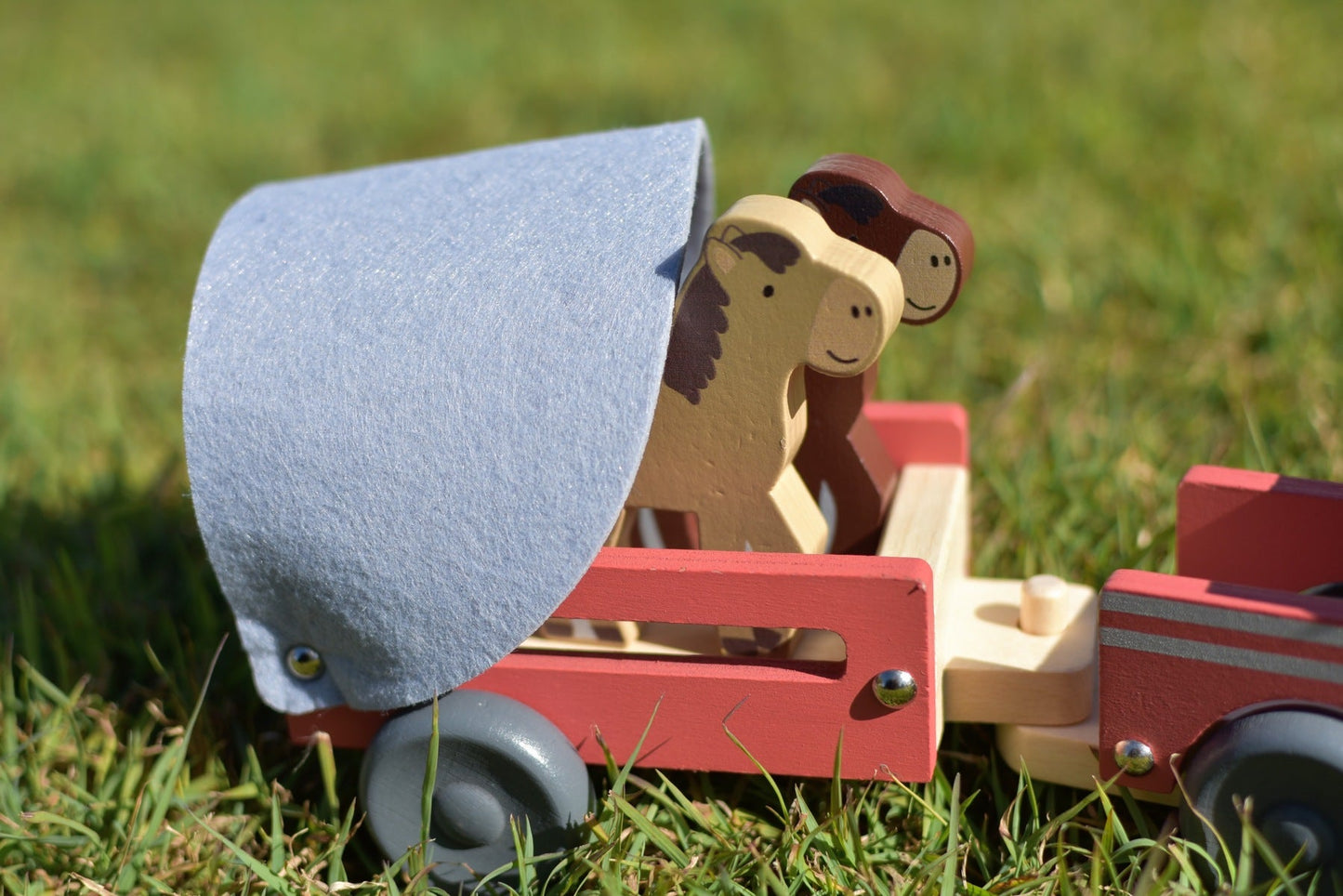 Wooden truck with detachable horse float, perfect for imaginative play in kids room.